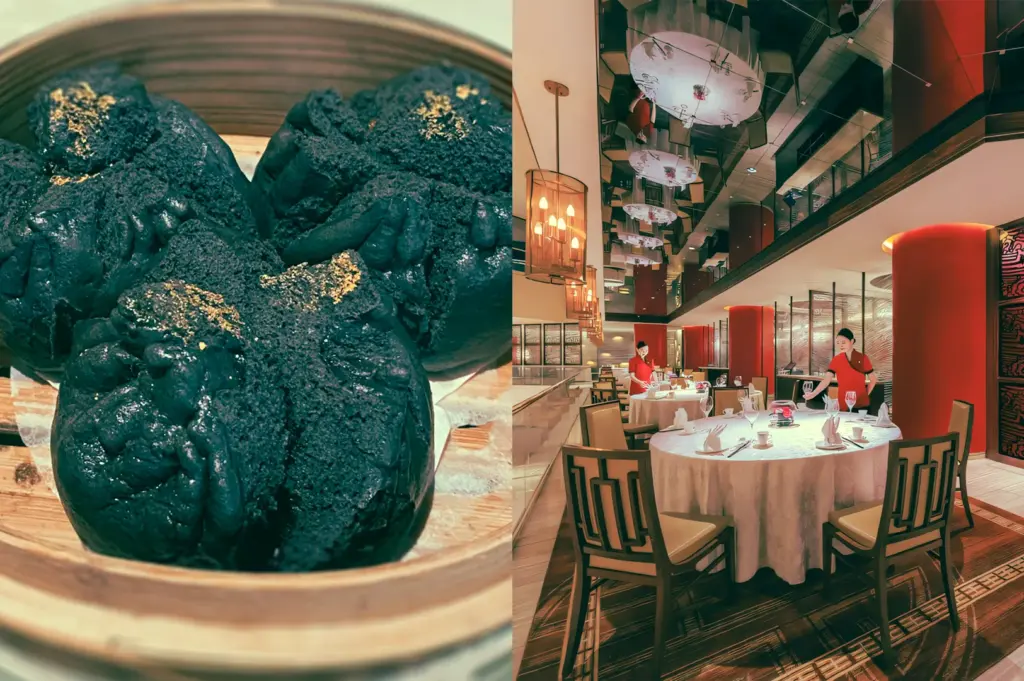 Left: Close-up, slightly elevated shot of three dark-colored steamed buns with textured surfaces and gold flecks placed inside a bamboo steamer, emphasizing contrast between matte dough and metallic highlights. Right: Wide-angle, eye-level interior shot of a modern Chinese fine dining restaurant with round tables dressed in white tablecloths, pendant lighting, tall red columns, reflective ceiling panels, and staff arranging table settings in a spacious dining hall.